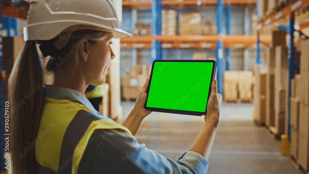 Professional Female Worker Wearing Hard Hat Uses Digital Tablet Computer with Green Chroma Key Scree