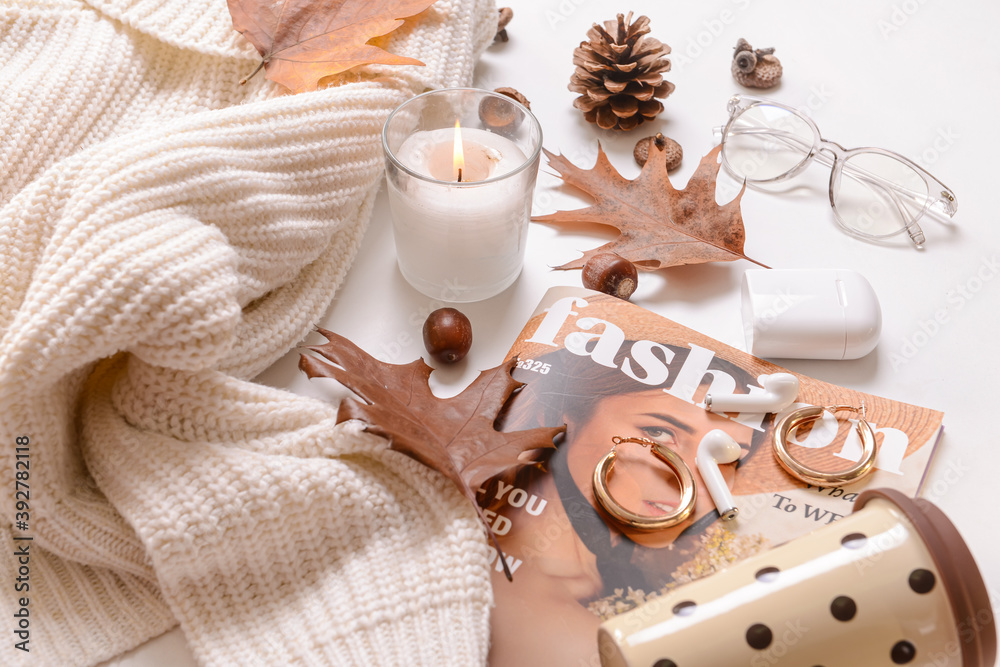 Autumn composition with stylish clothes, candle and magazine on white background
