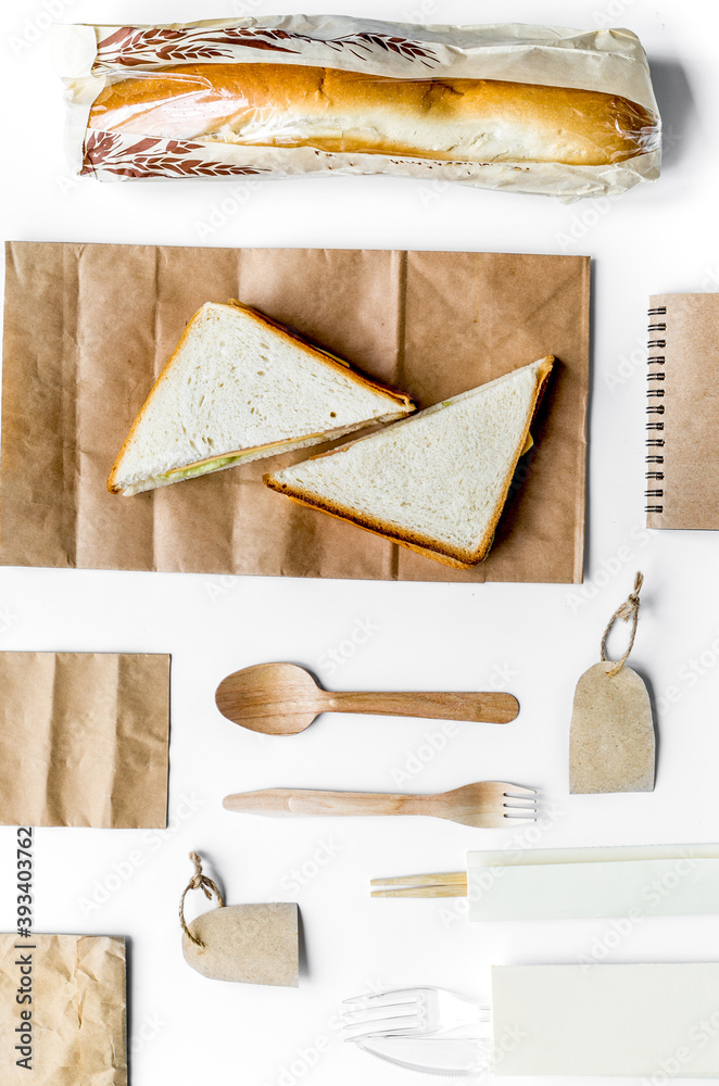 纸袋和三明治白色背景的食品配送俯视图实物模型