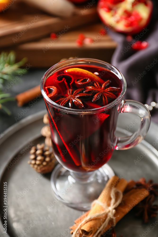Glass cup of tasty mulled wine on table, closeup