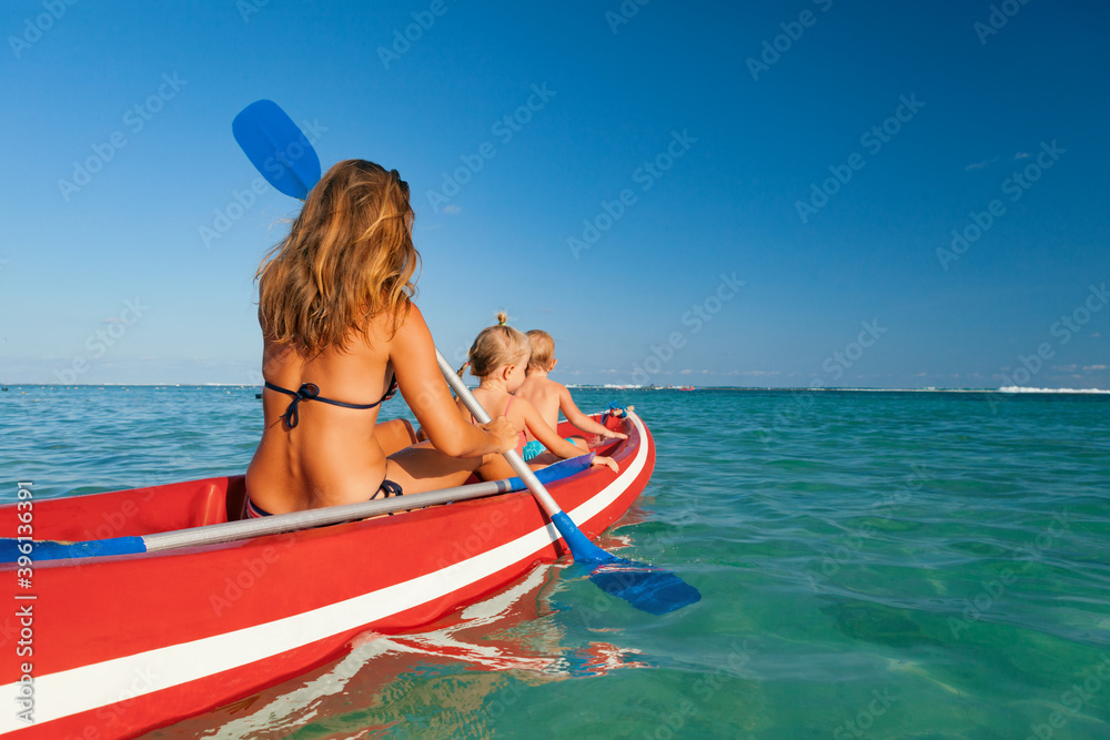 Happy family - young mother, children have fun on boat walk. Woman and child paddling on kayak. Trav