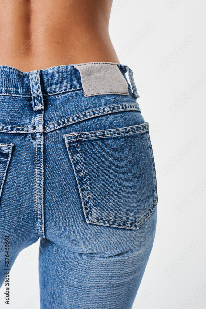 Woman in a blue jeans with a tag mockup