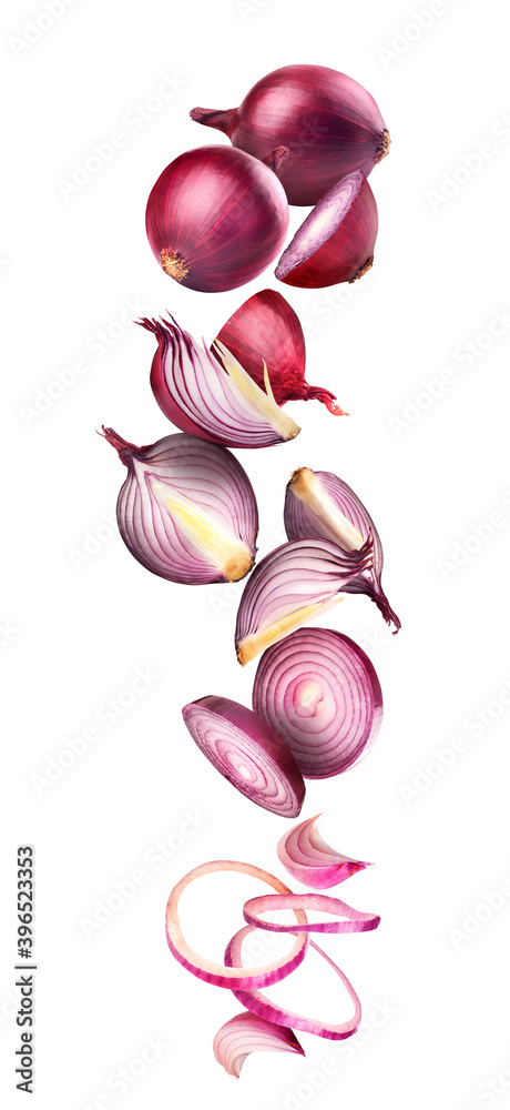 Chopped and whole onions in flight on a white background