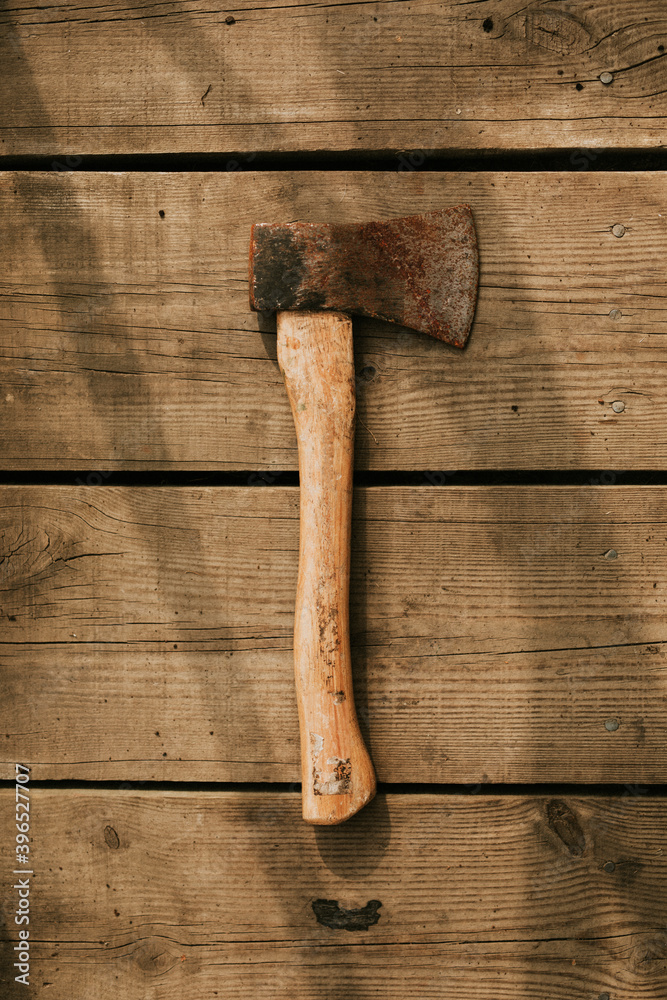 Rustic axe on a wooden background flatlay