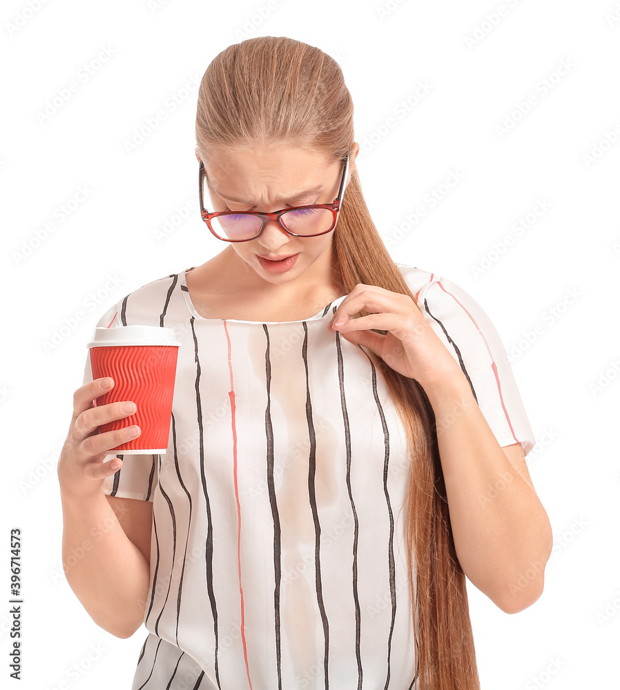 Stressed young woman with coffee stains on her t-shirt on white background