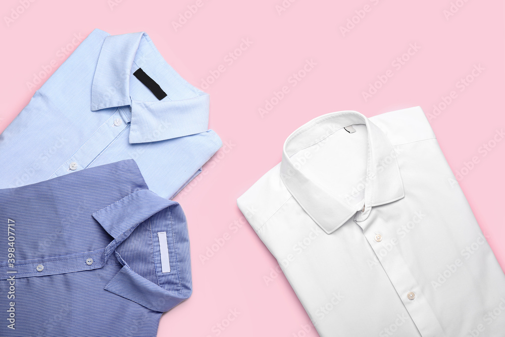 New male shirts on color background