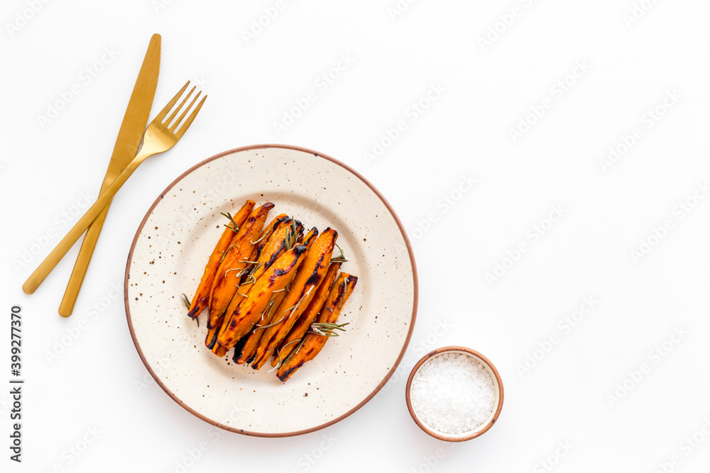 Overhead view of sweet potato fries with spices and herbs