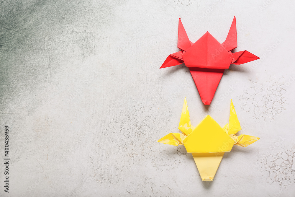 Origami bulls as symbol of year 2021 on light background