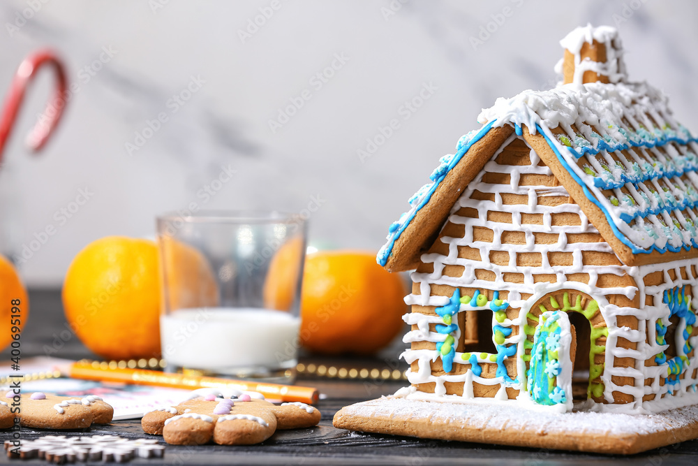 Beautiful gingerbread house and Christmas decor on table