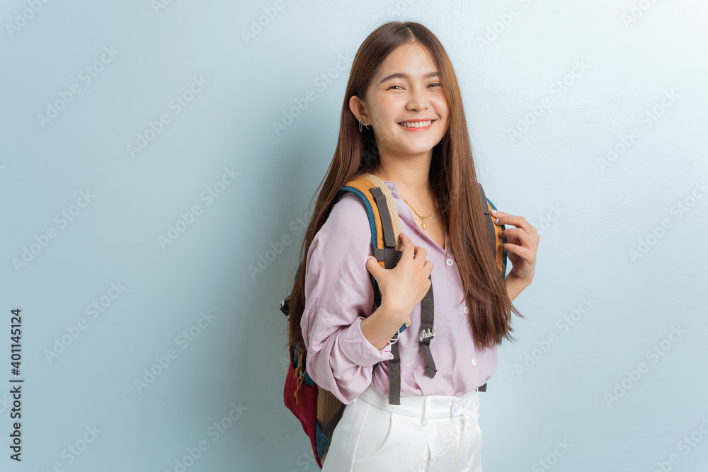 Asian female student carrying a bag, smiling beauty