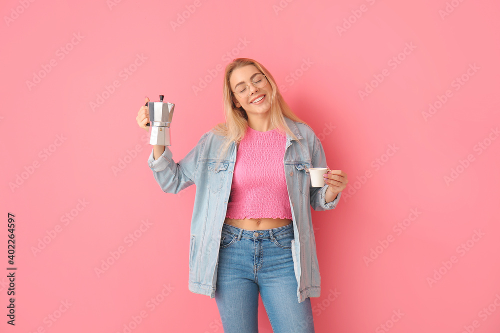 美丽的年轻女子在彩色背景下喝热咖啡