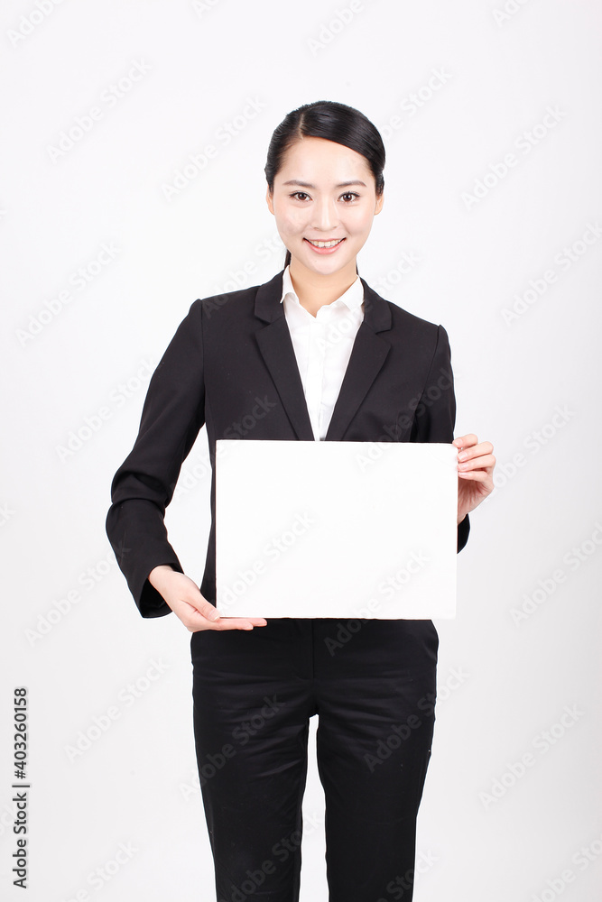 A business woman holding a white board