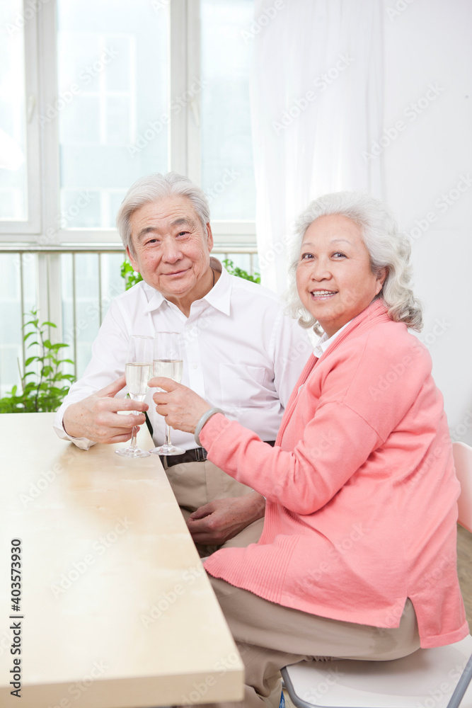 An old senior couple toasting for anniversary 