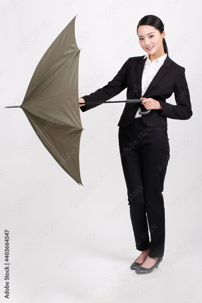 一个年轻的商业女性撑着伞