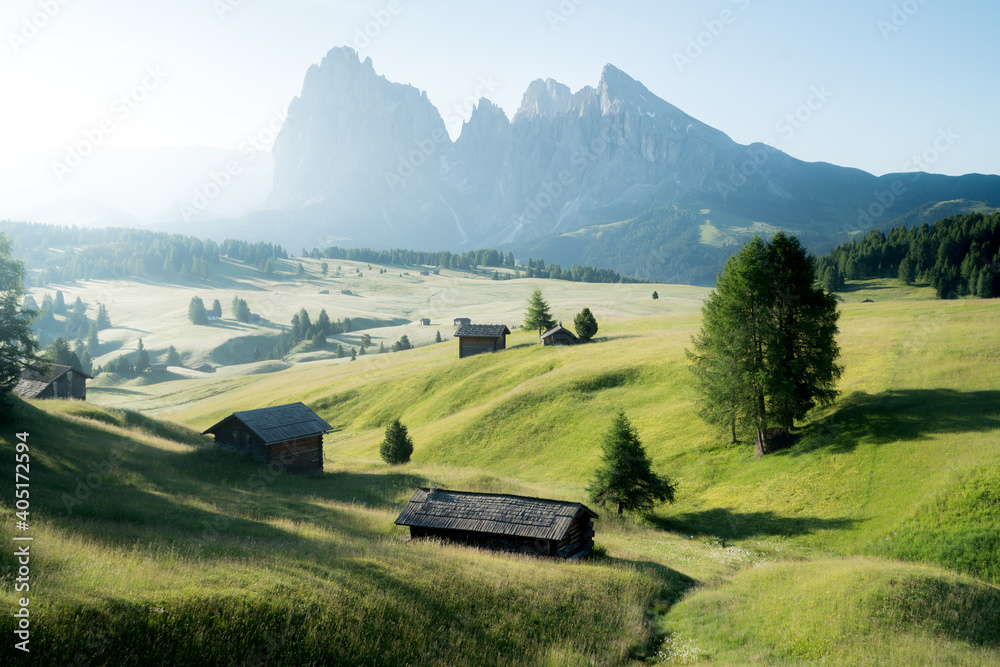 Scenic alpine landscape with mountain huts in the Alps at sunrise in summer