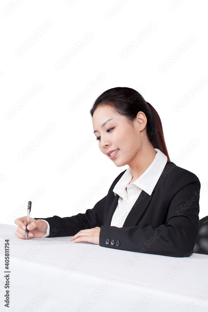 Businesswoman writting at a table with smile