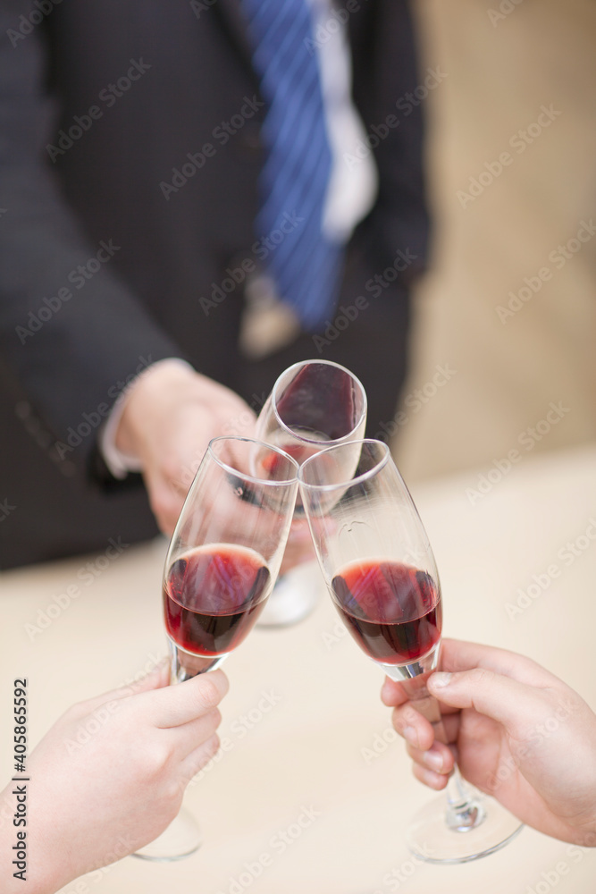 Portrait of businessman holding a glass of wine and toasting,close-up