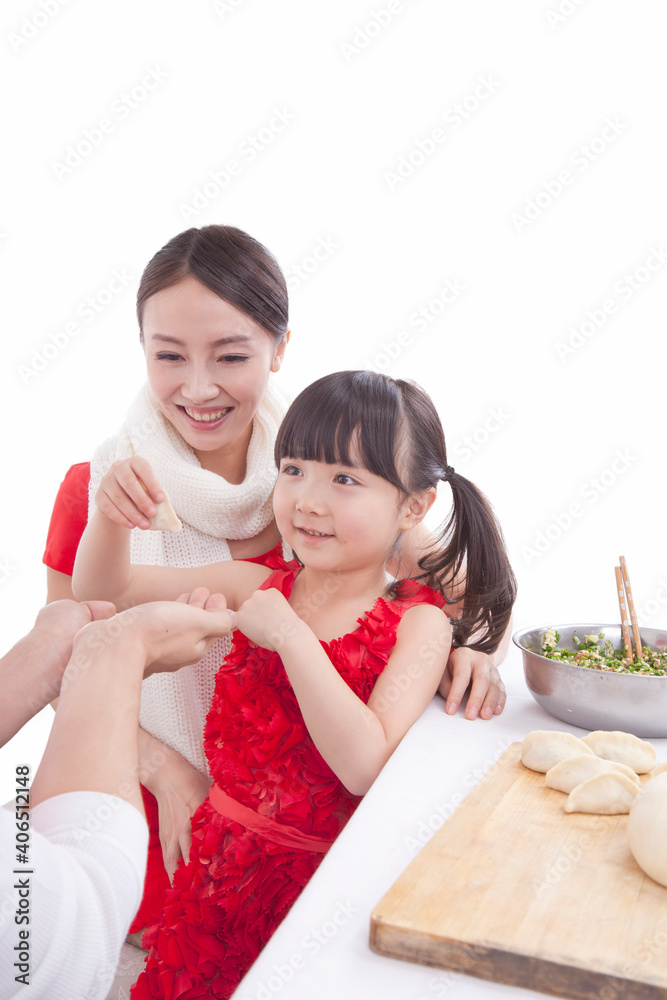 Portrait of daughter with parents making dumplings 