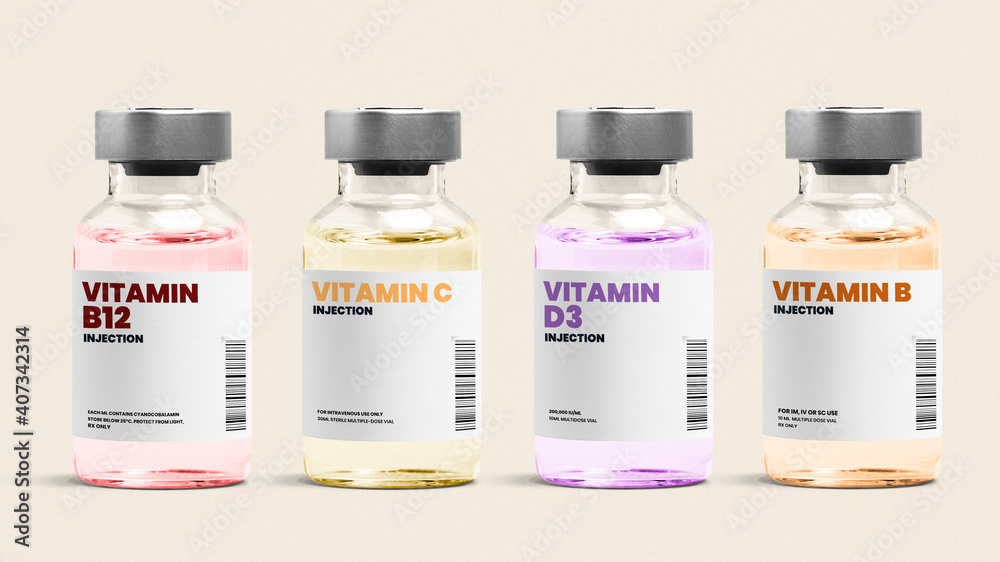 Vitamin injection glass bottles on beige background