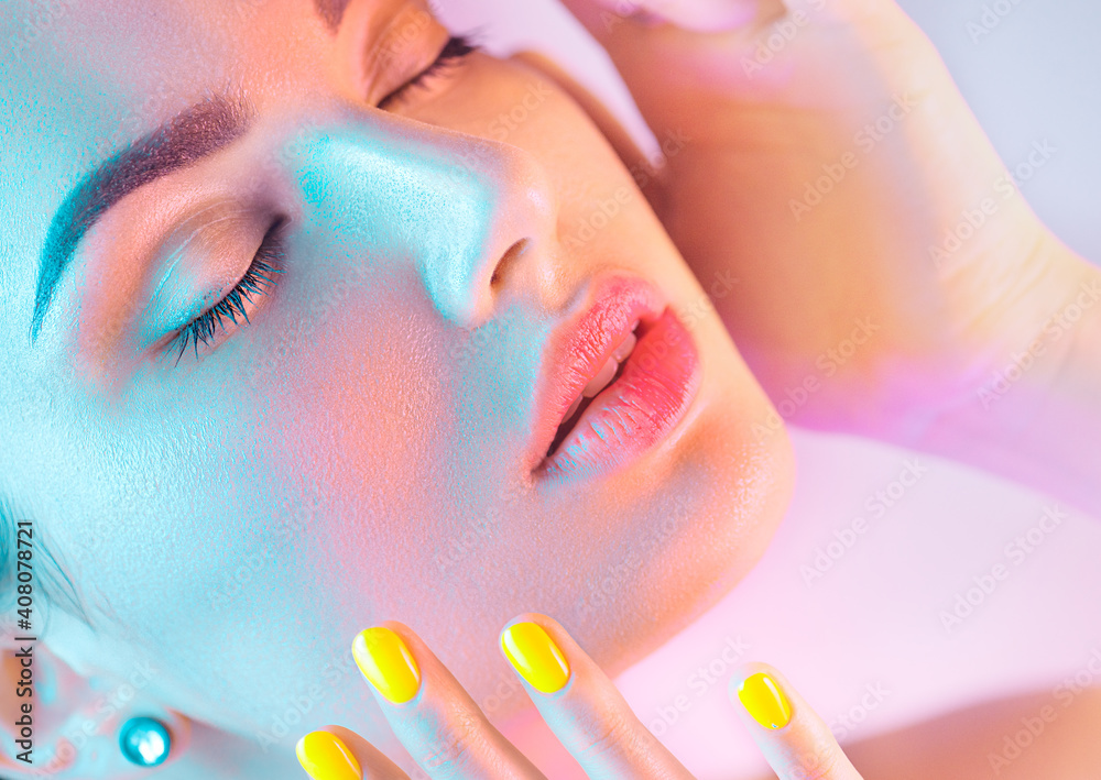 High Fashion model girl in colorful bright UV lights posing in studio, portrait of beautiful woman w