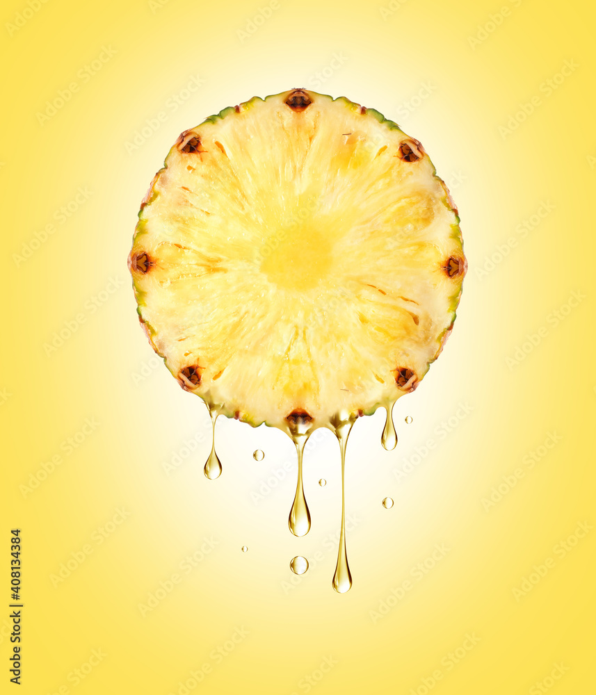 Drops of juice dripping from half a pineapple close-up on yellow background