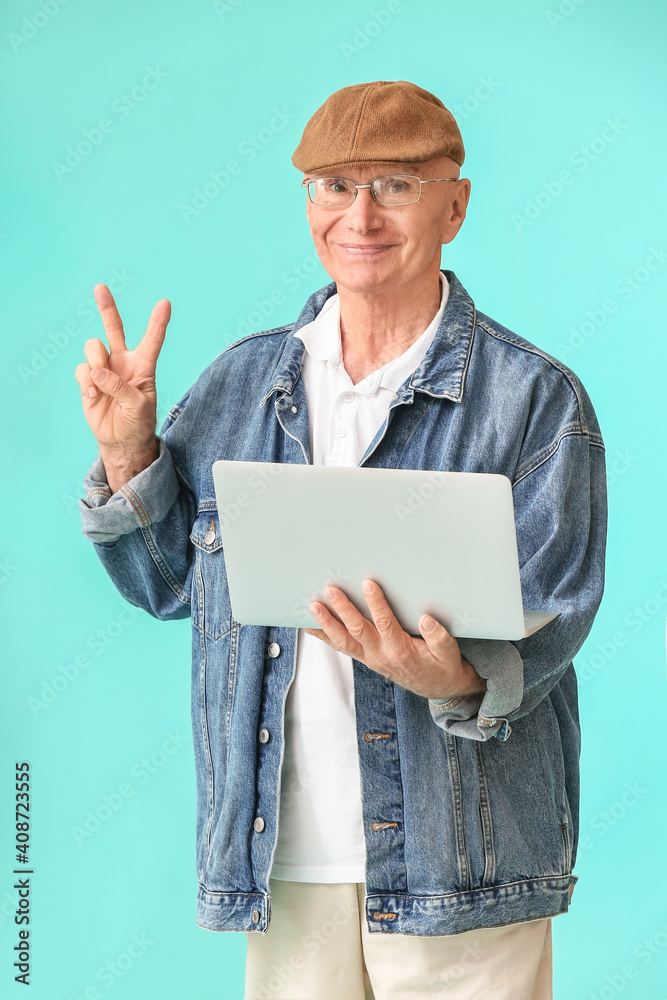 带彩色背景笔记本电脑的老人