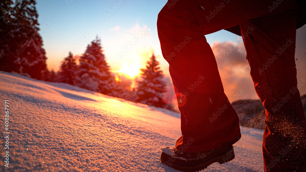 特写：日落时，兴奋的女游客在闪闪发光的新鲜粉末雪中奔跑。