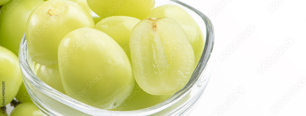 Beautiful Shine Muscat green grape in a glass cup isolated on white background.