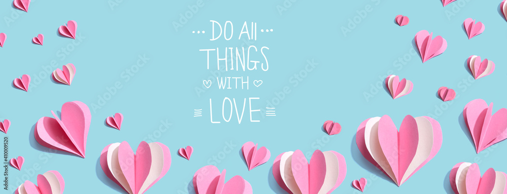Do all things with love message with pink paper hearts - flat lay