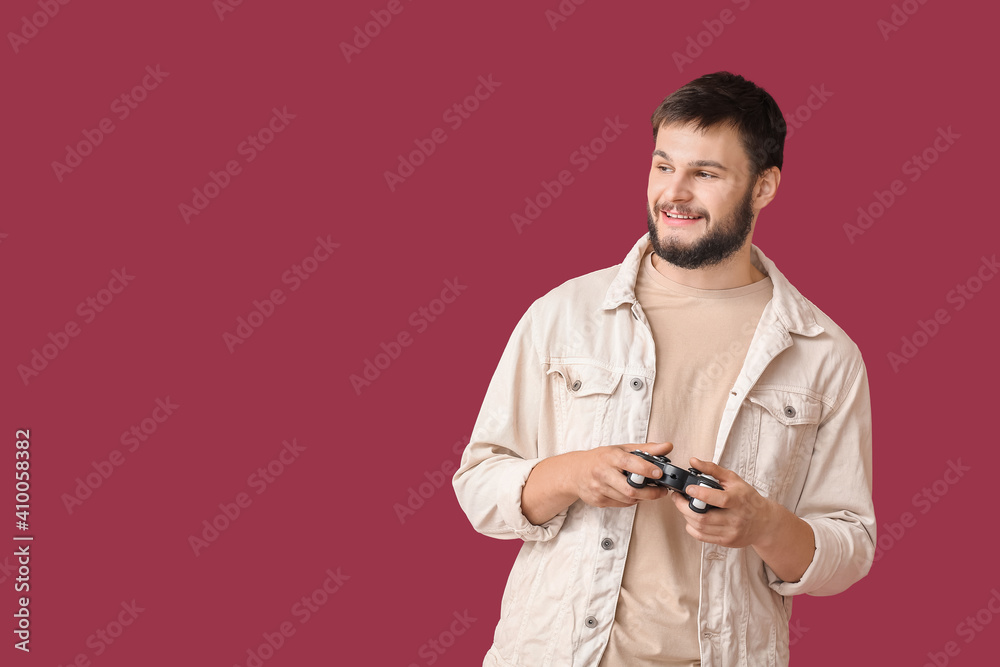 年轻人在彩色背景下玩电子游戏