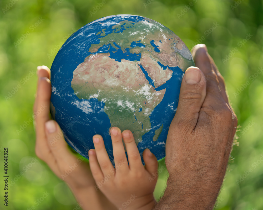 Family holding blue planet in hands. Earth day spring holiday concept. Elements of this image furnis