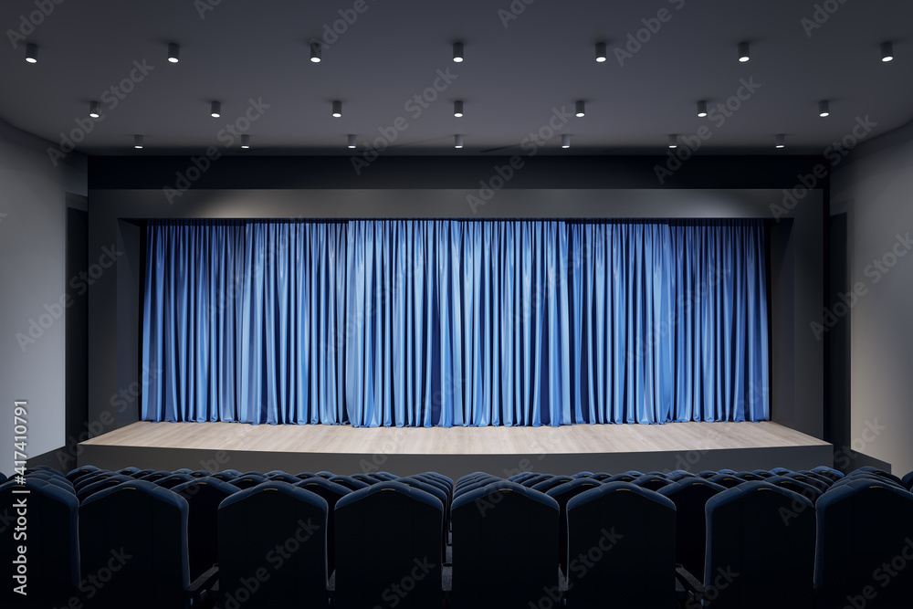蓝色窗帘、一排排座位和顶部灯光的剧院大厅空荡荡的场景的正面视图