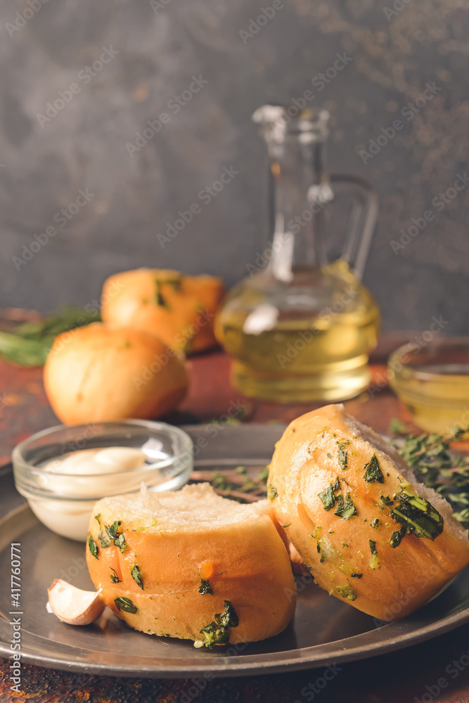 Composition with fresh bread and different spices on dark background