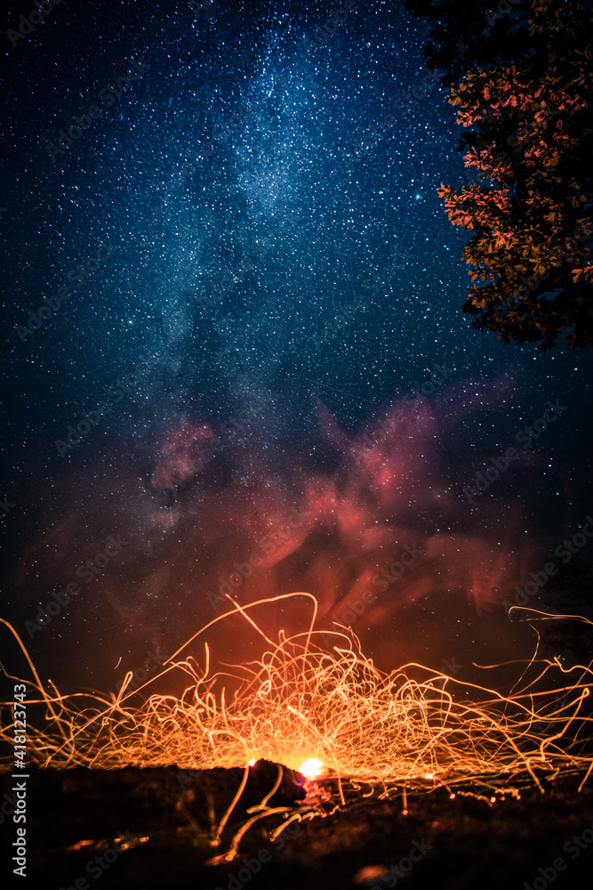 Luminous fire patterns on night sky background