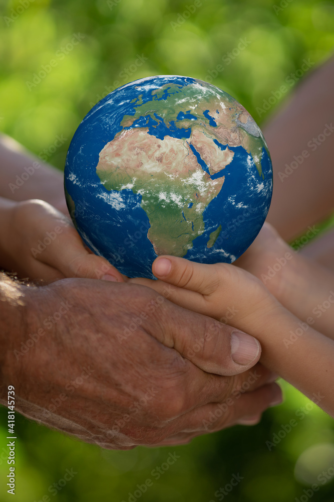 Family holding Earth planet in hands.Elements of this image furnished by NASA
