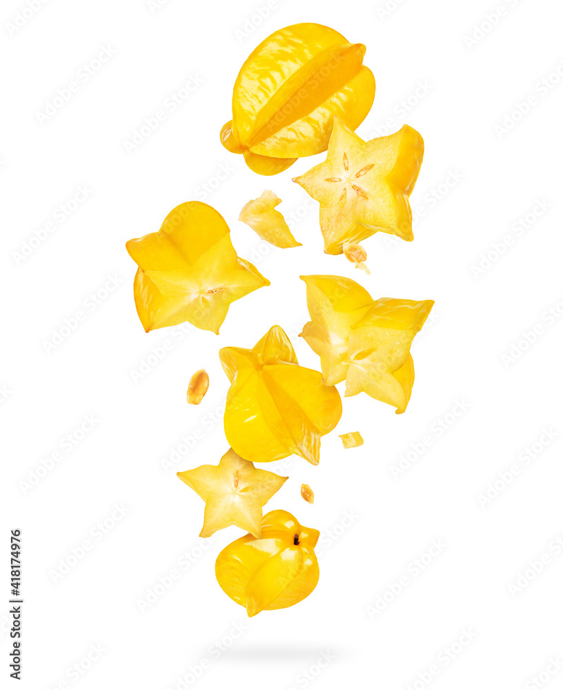Whole and sliced ripe carambola in the air, isolated on a white background