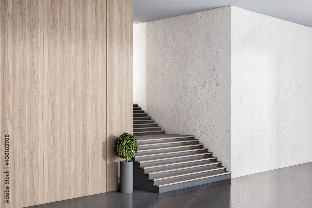 宽敞大厅混凝土和木墙之间的黑色木楼梯。3D渲染，实体模型