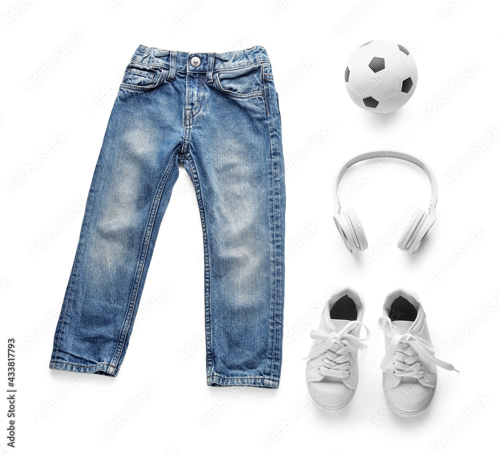 Childs clothes, shoes, ball and headphones on white background