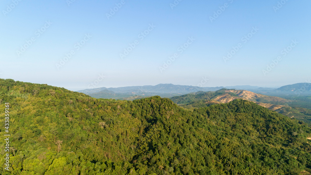 Aerial view of Beautiful mountain landscape with mountain peaks covered with forest and blue sky in 