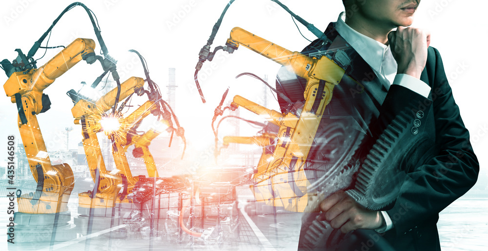 Mechanized industry robot arm and factory worker double exposure . Concept of robotics technology fo