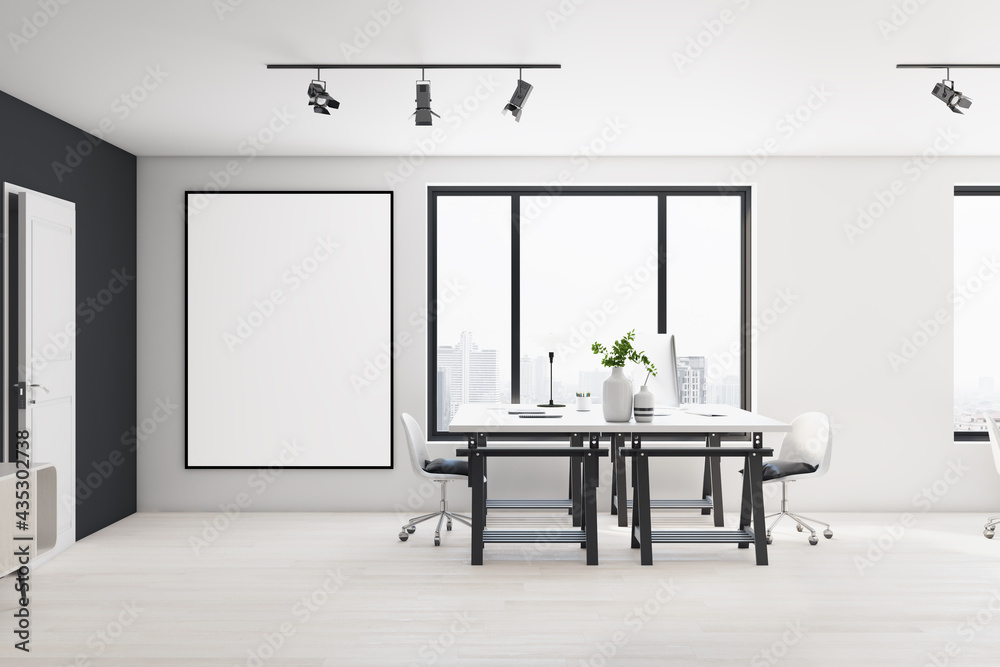 Blank white poster in black frame on light wall in stylish open space office with modern design, whi