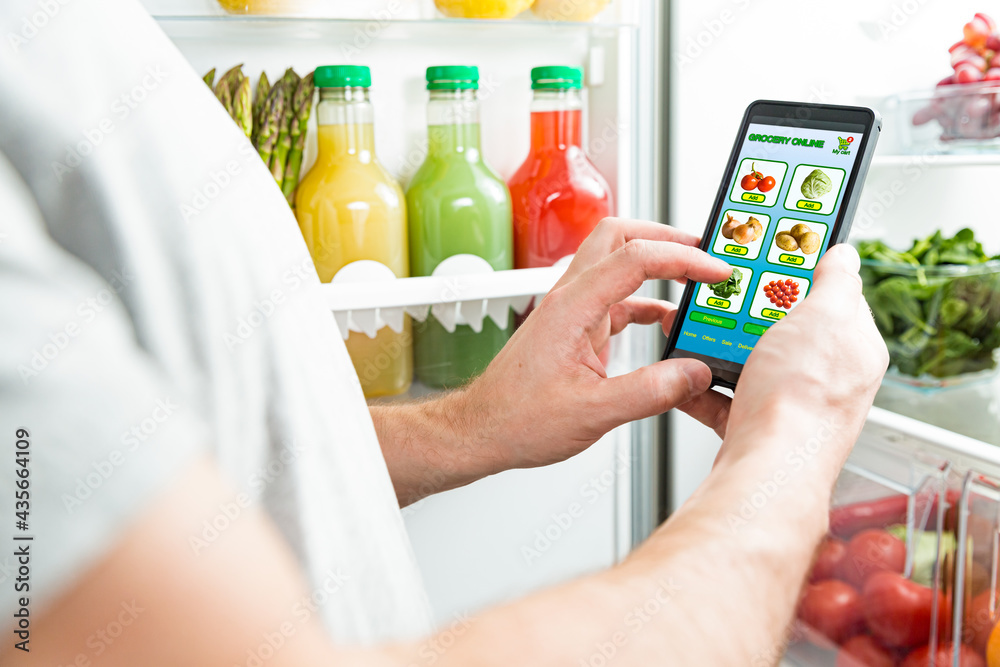Man using smart phone, buying food. Close-up hand with phone. Grocery shopping online. Mobile app of