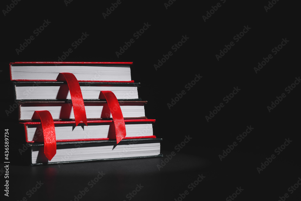 Books with bookmarks on dark background