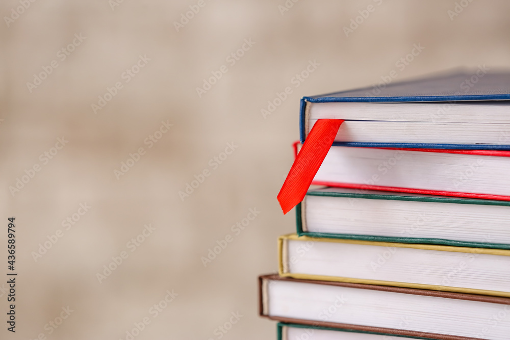 Books with bookmark on light background, closeup