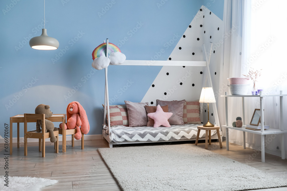 Interior of stylish childrens room with glowing lamp