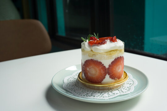 Strawberry shortcake with rosemary leaf in cafe