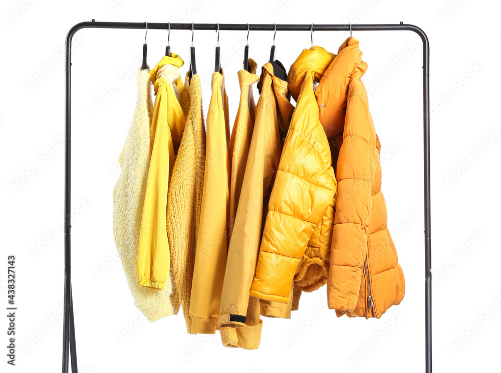 Rack with modern clothes on white background