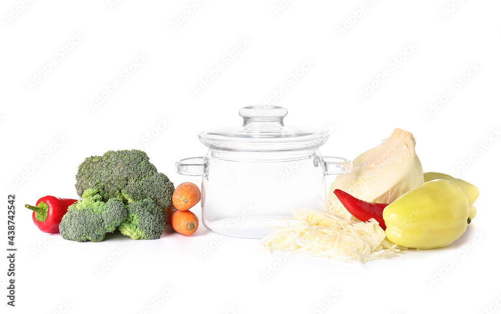 Stylish cooking pot and vegetables on white background