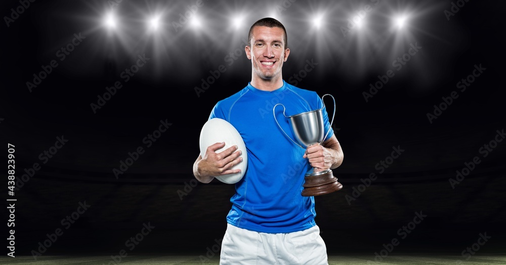 男子橄榄球运动员庆祝胜利，在体育场捧起奖杯的构成
