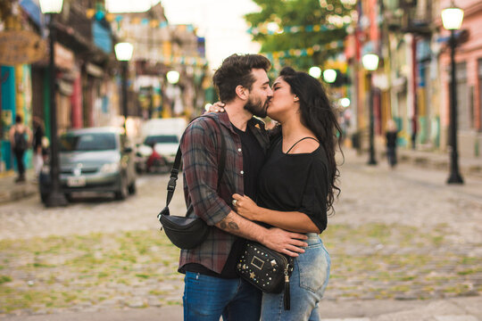 Couple kissing in a colorful street